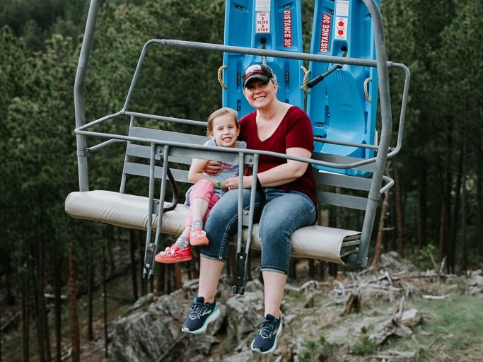 Mom and daughter riding the chairlift in the rushmore adventure park